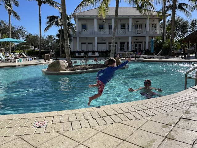 A group of people jumping into a pool

Description automatically generated with medium confidence