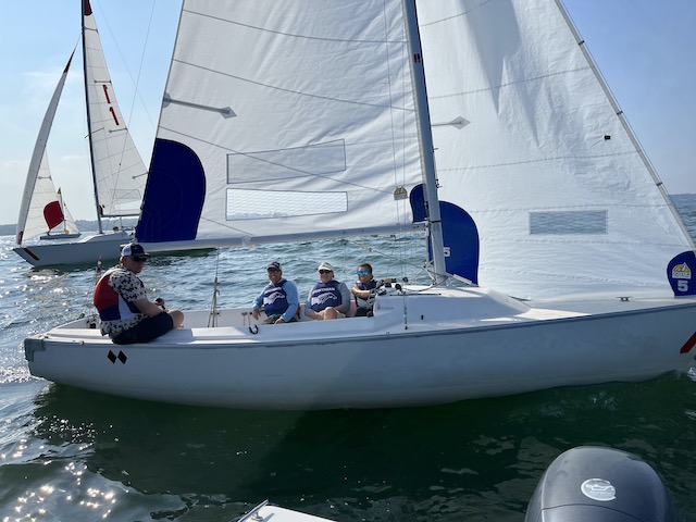 A group of people on a sailboat

Description automatically generated