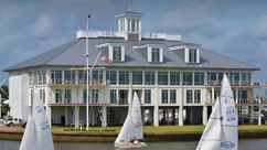 A sailboat in front of a building

Description automatically generated with low confidence