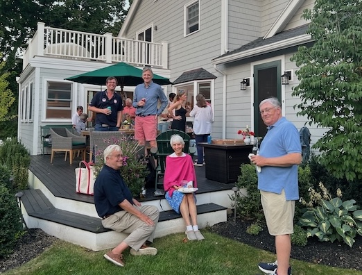 A group of people on a porchDescription automatically generated