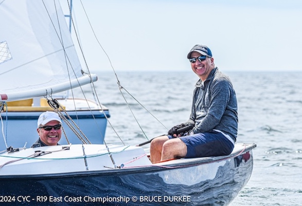 Two men sitting in a boatDescription automatically generated