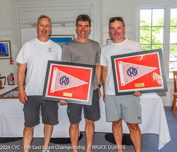 A group of men holding up signsDescription automatically generated