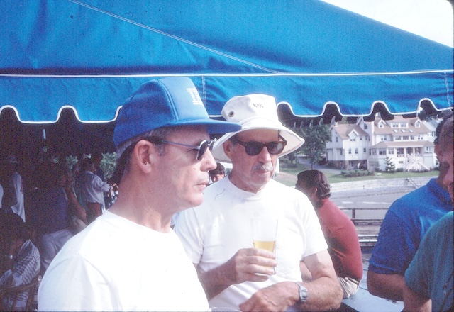 A couple of men wearing white shirts and hatsDescription automatically generated