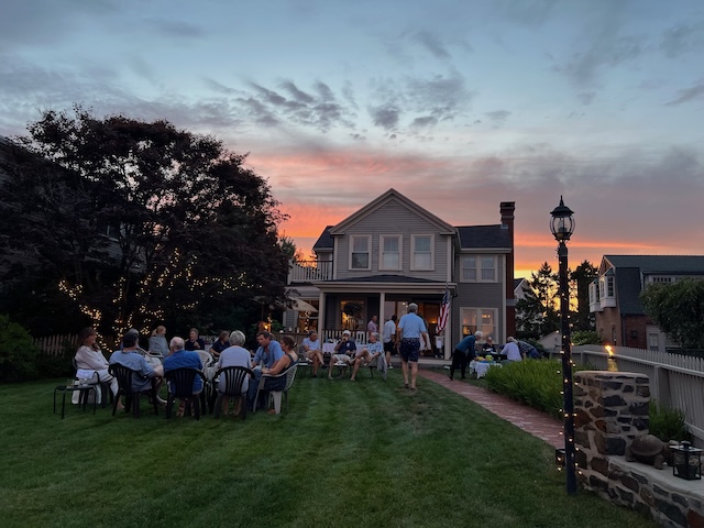 A group of people sitting in a lawnDescription automatically generated